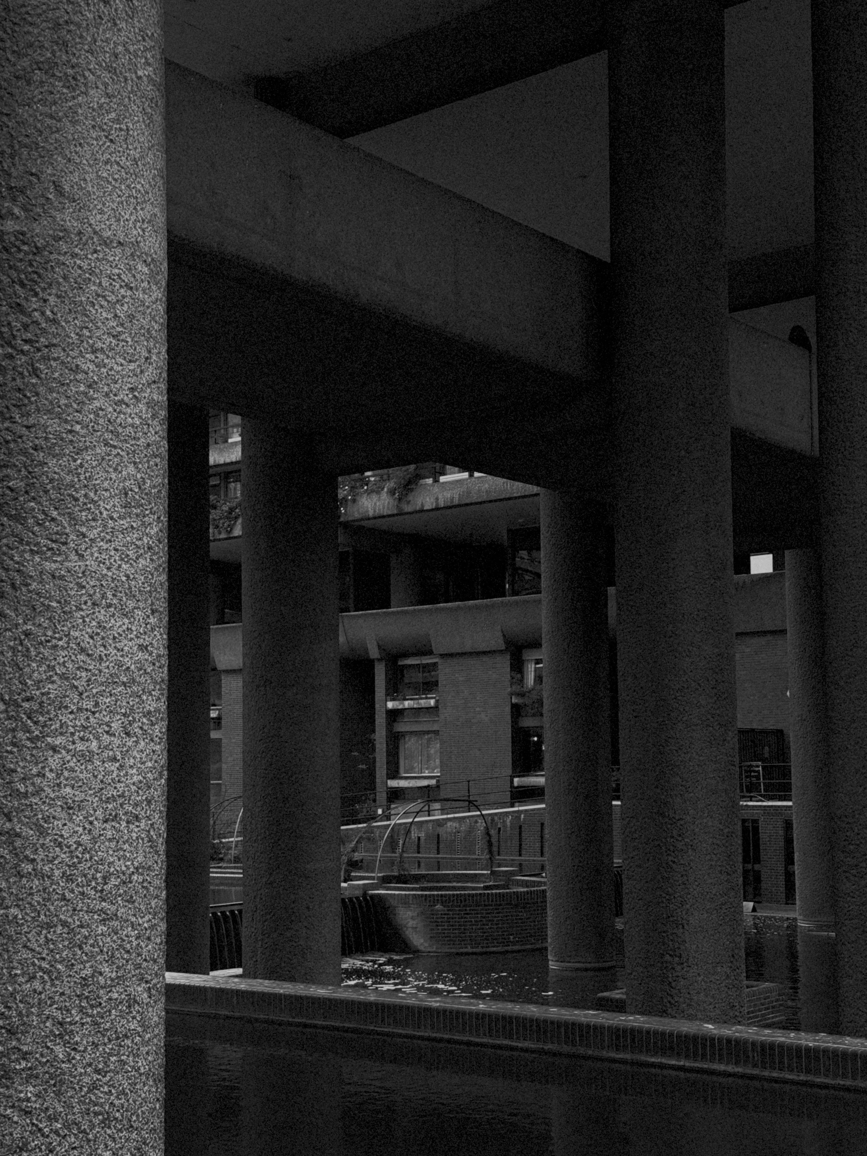Black-and-white photograph of concrete columns and walkways.